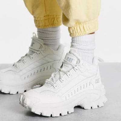 White chunky trainers worn with yellow joggers